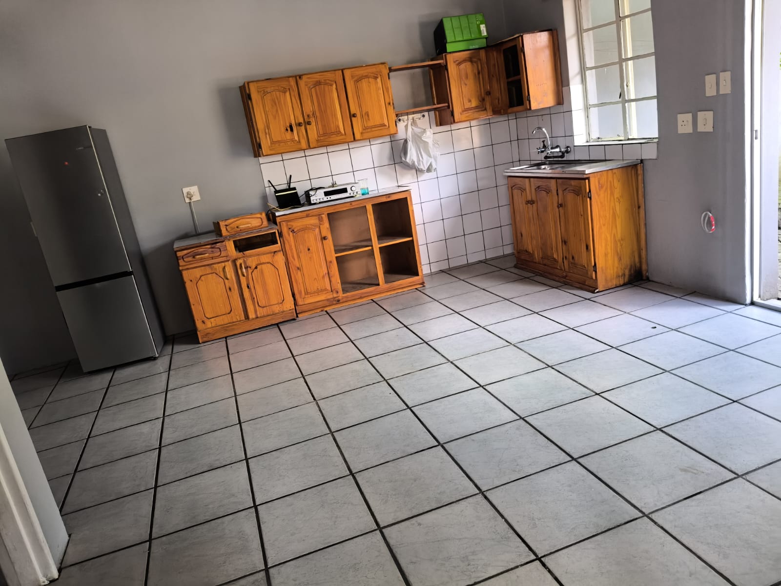 Empty kitchen with clean tiled floor