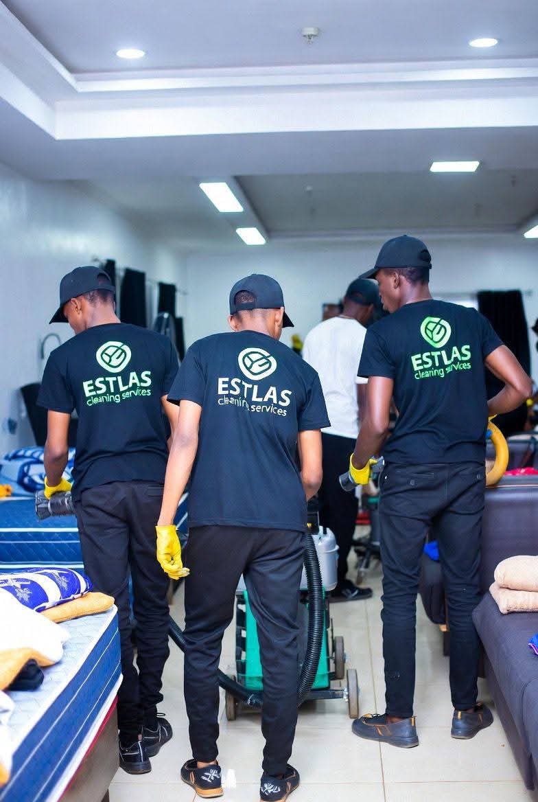 Estlas team in branded shirts at work with cleaning equipment