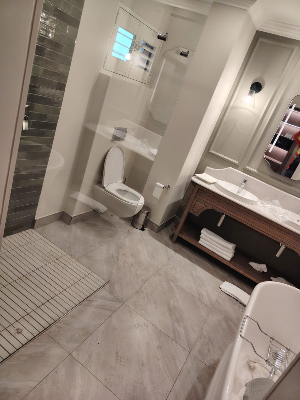Clean hotel-style bathroom with vanity and bath