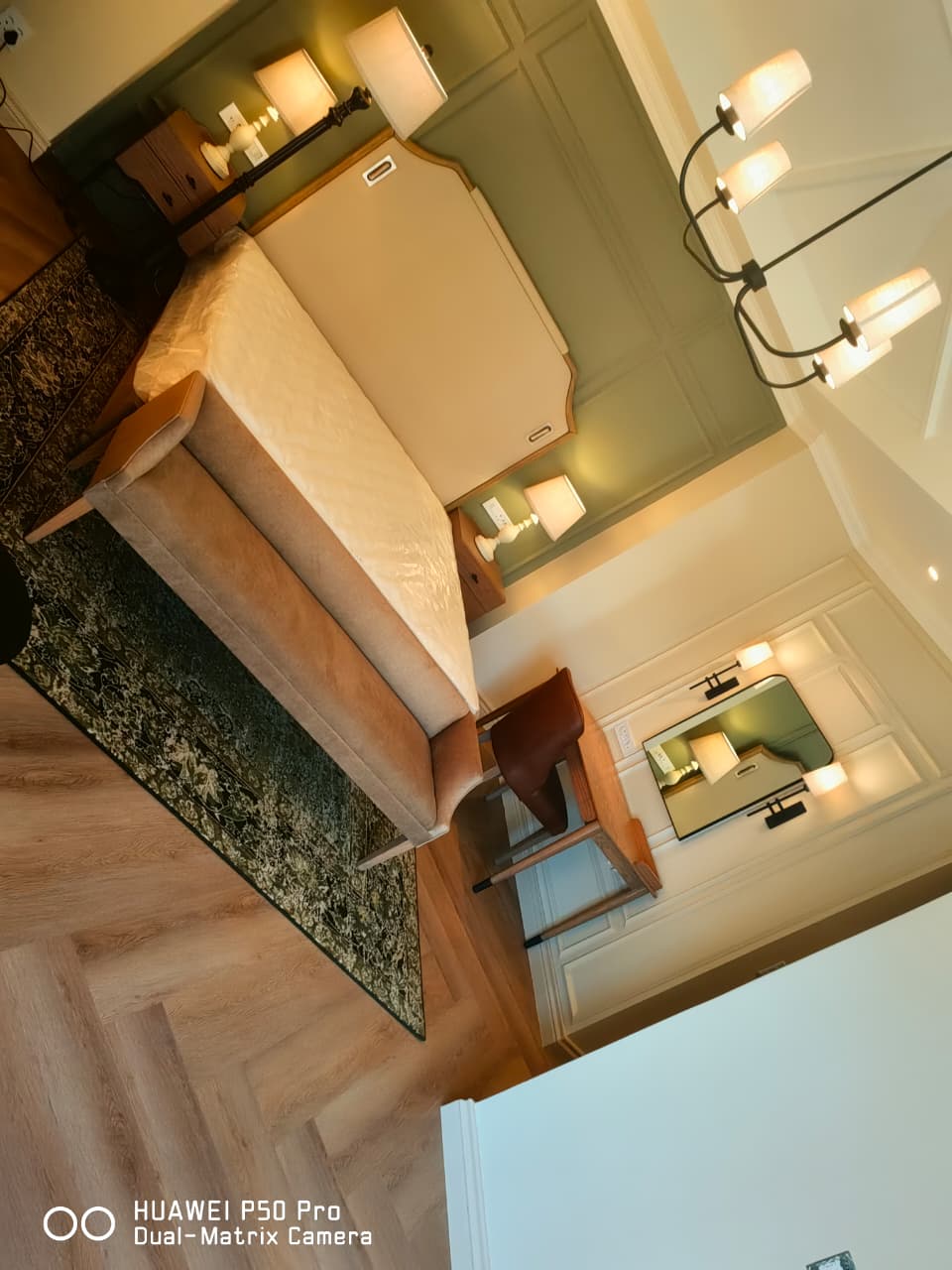 Bedroom with an upholstered bed, rug and bedside tables