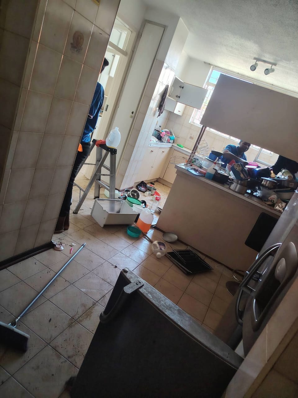 Team working through a busy kitchen clean
