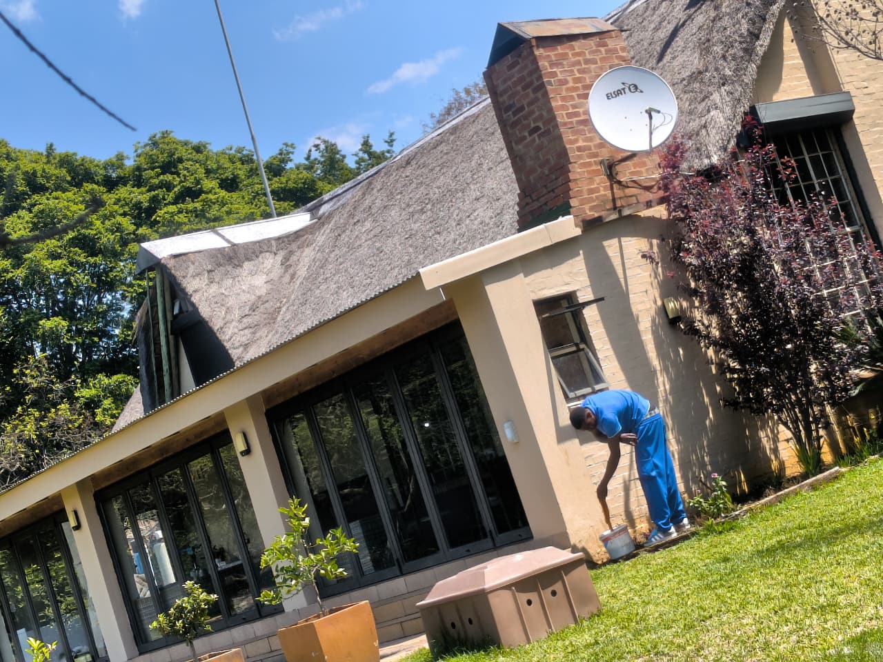 Cleaner washing the outside wall of a house