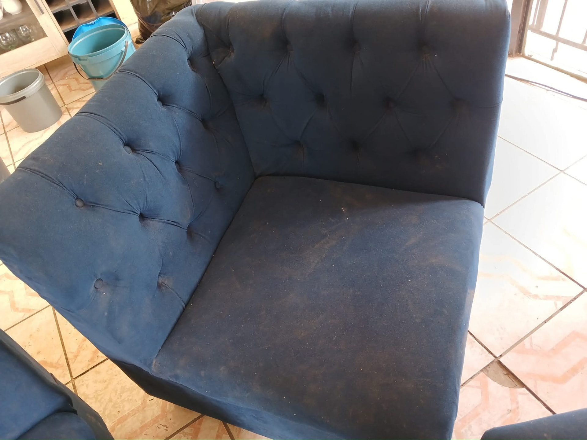 Close view of a blue tufted velvet couch