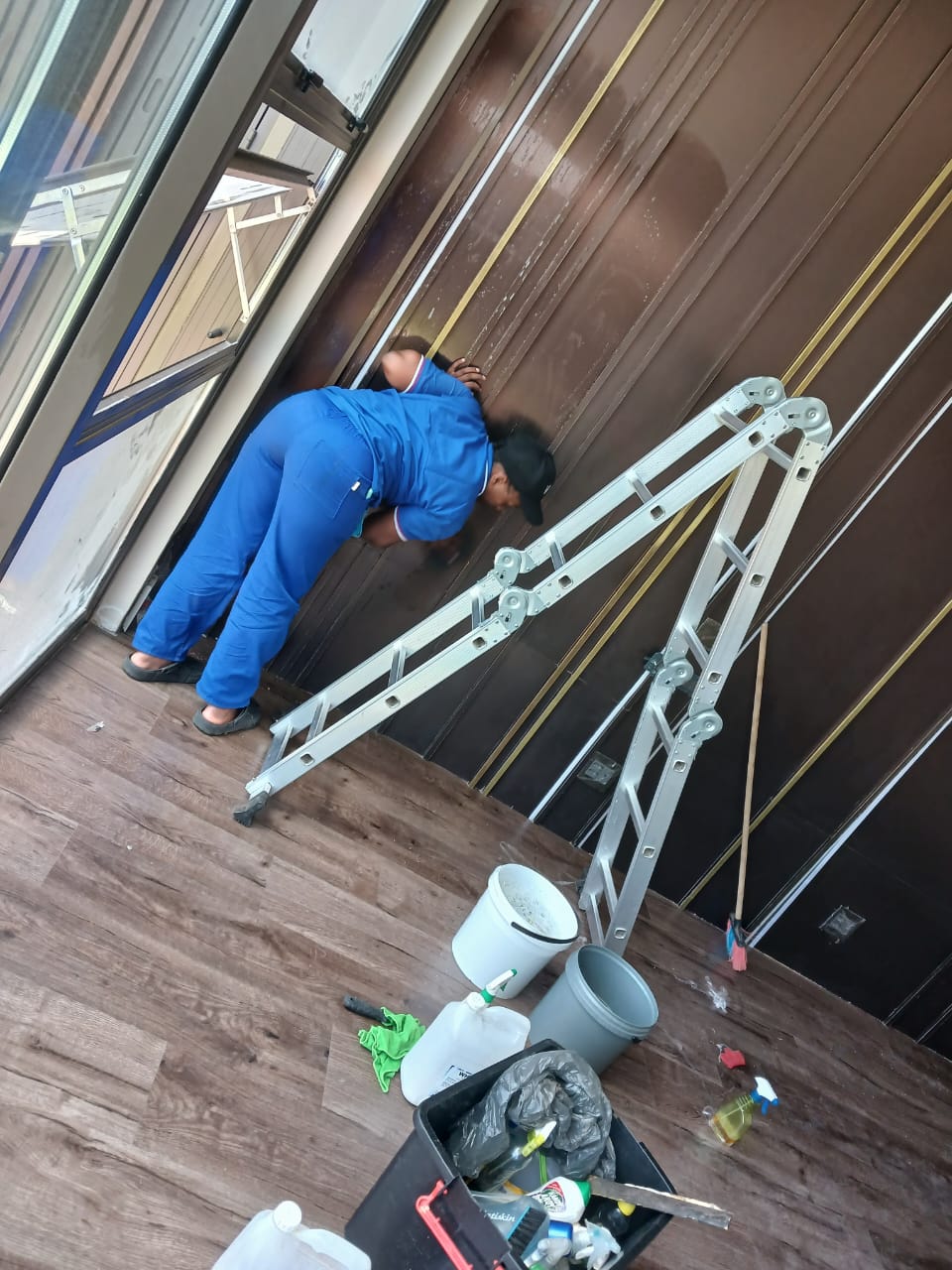 Cleaner detailing dark wall panels in a new build