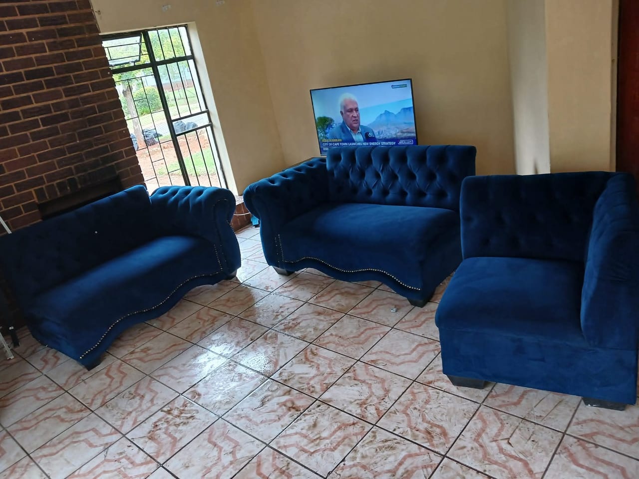 Blue velvet lounge suite in a living room after cleaning